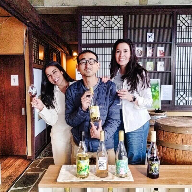 Guests enjoying a wine tasting session at a Yamanashi winery.