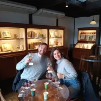 Two guests tasting red and white wines in the historic tasting room at Marufuji Winery in Yamanashi