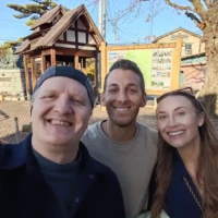 Wine tour guide and two guests smiling after a day of wine tasting in Yamanashi’s Koshu Valley